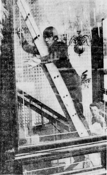 Benjamin Philibert, 18, applies sensitized metal foil to a window at Warfield Shops in 1971
